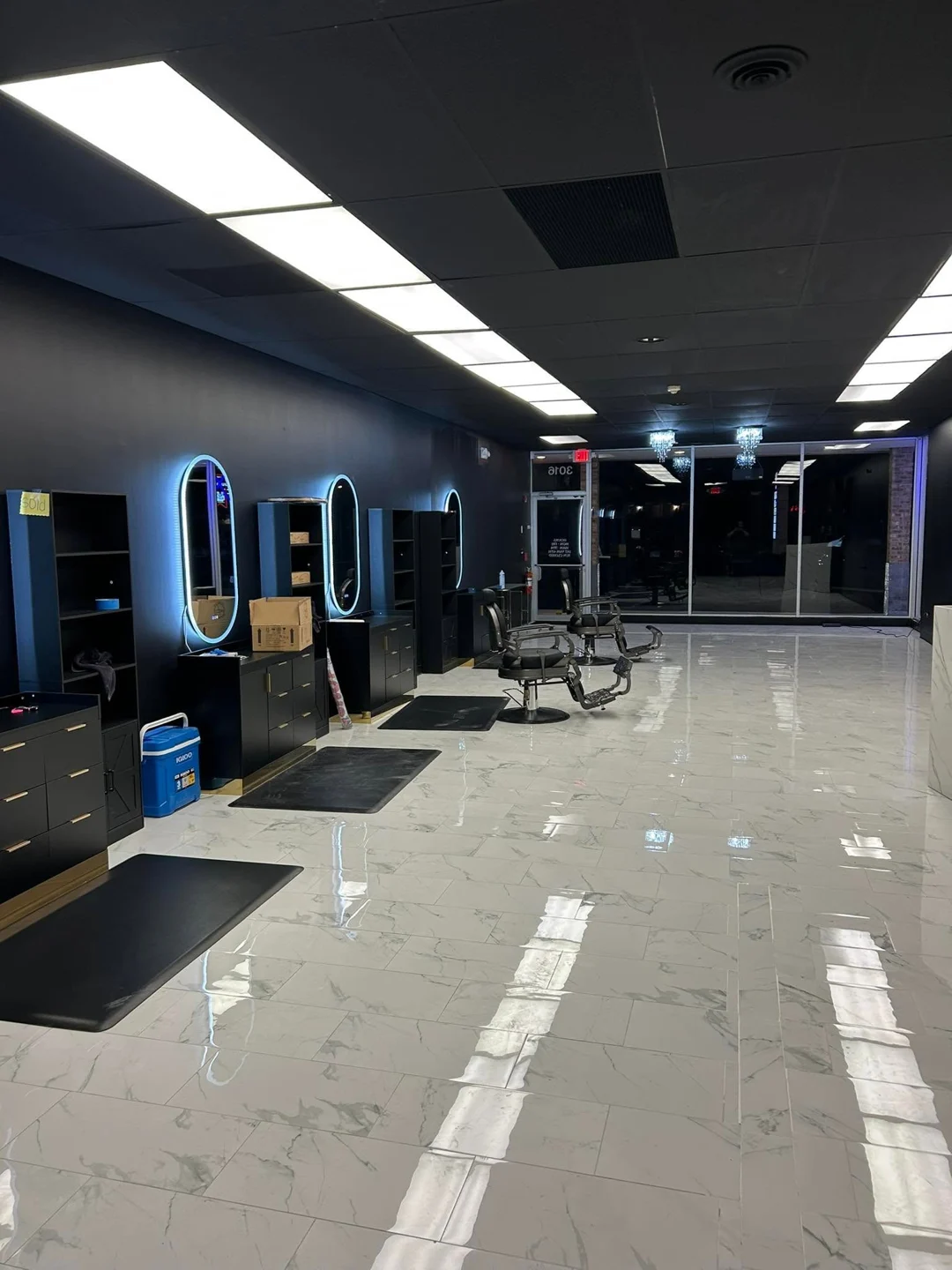 Barber chairs and illuminated mirrors inside Axis Cuts