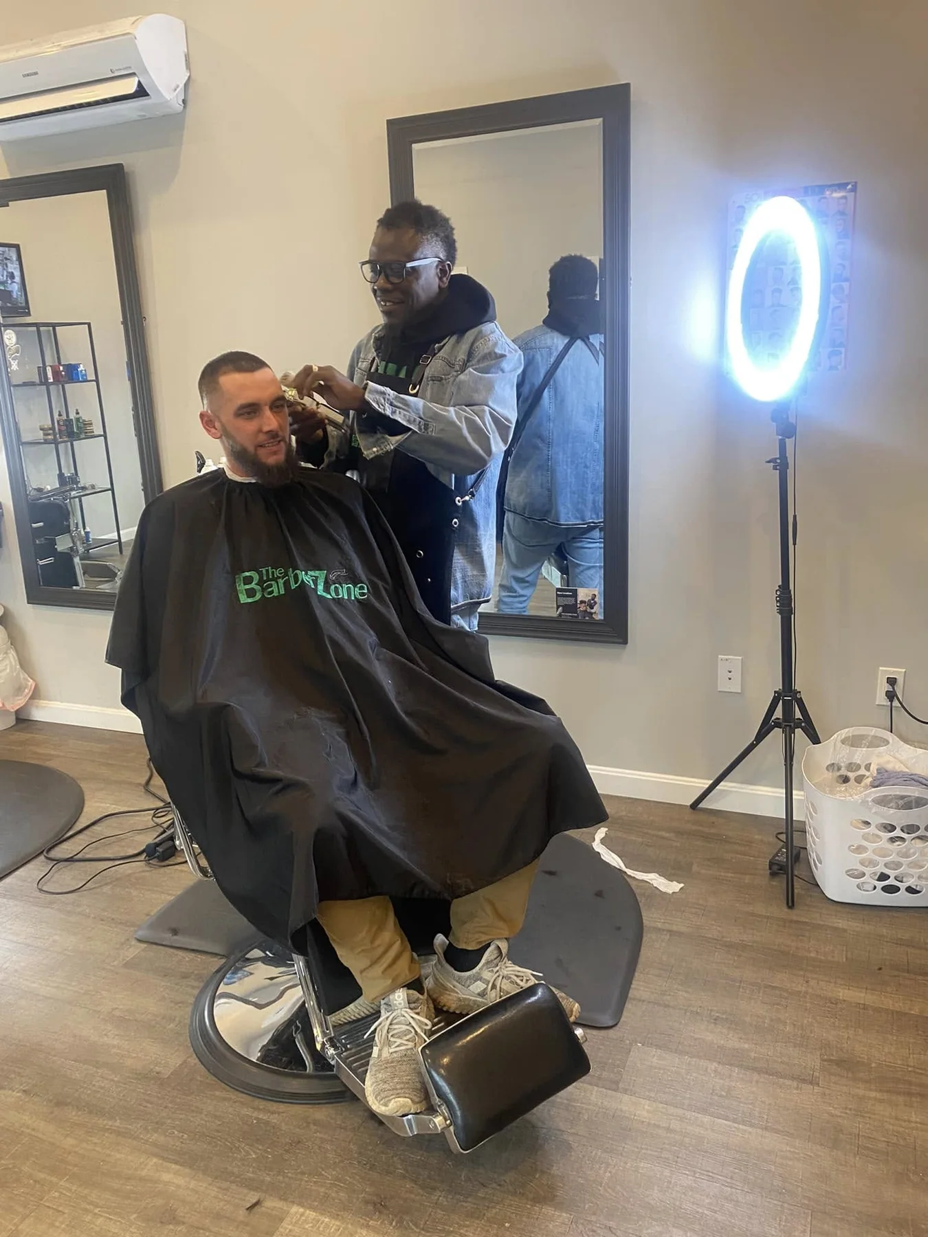 Barber working with a client inside The Barber Zone