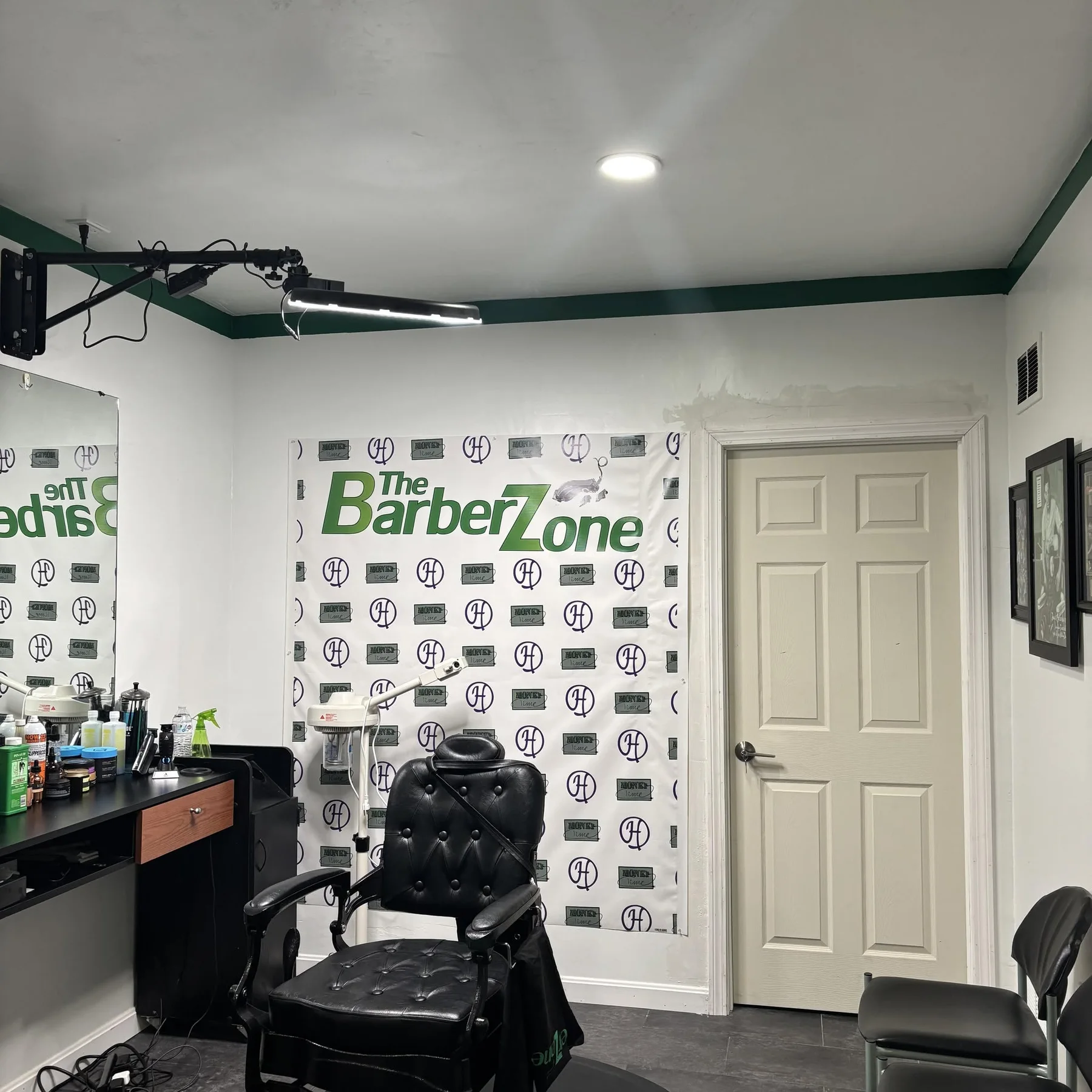 Barber chair and branded Barber Zone wall inside the shop