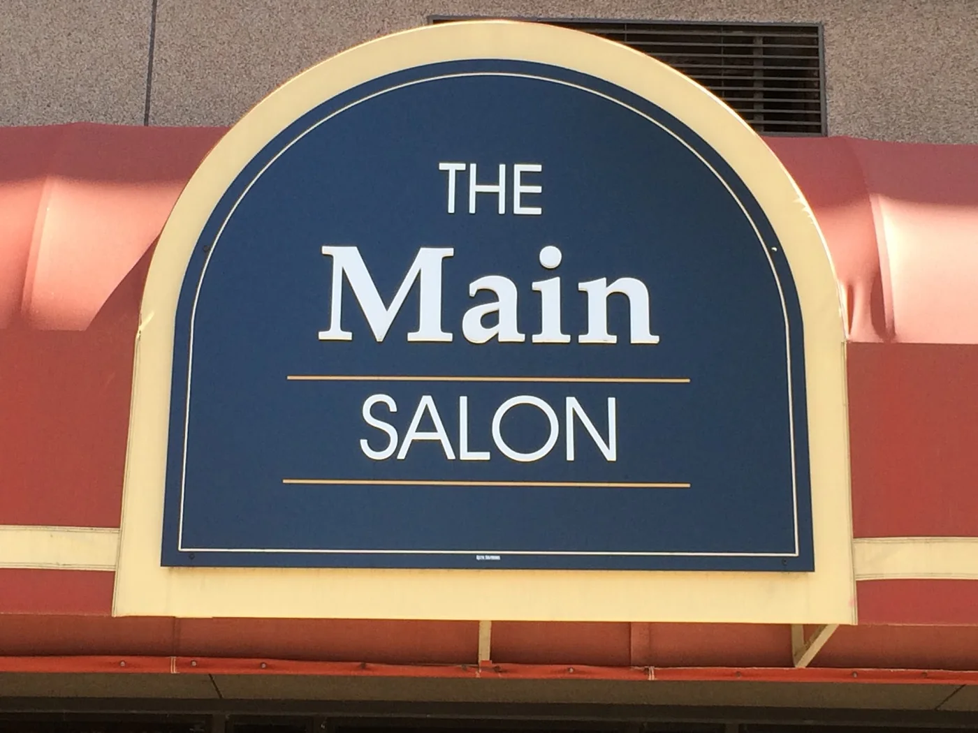 The navy and cream Main Salon sign