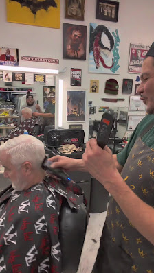Barber working on a client's haircut at Urban Styles